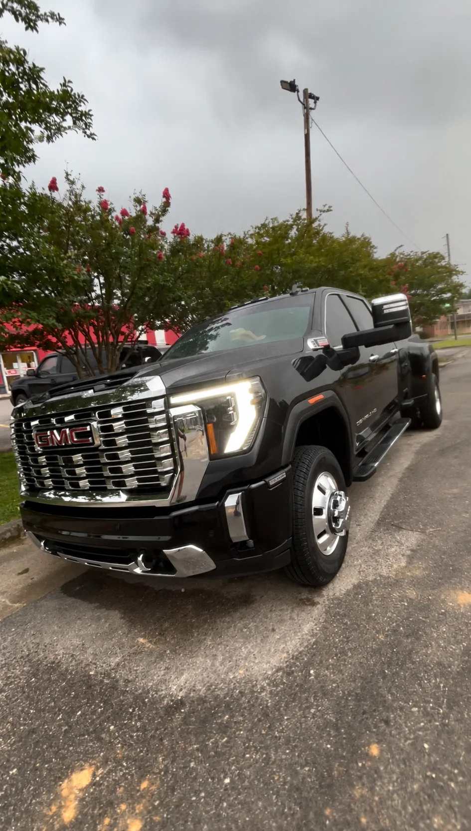 Black GMC Denali truck with chrome wheels