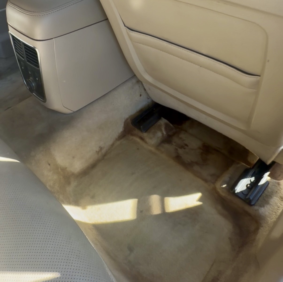 Stained vehicle carpet before interior cleaning