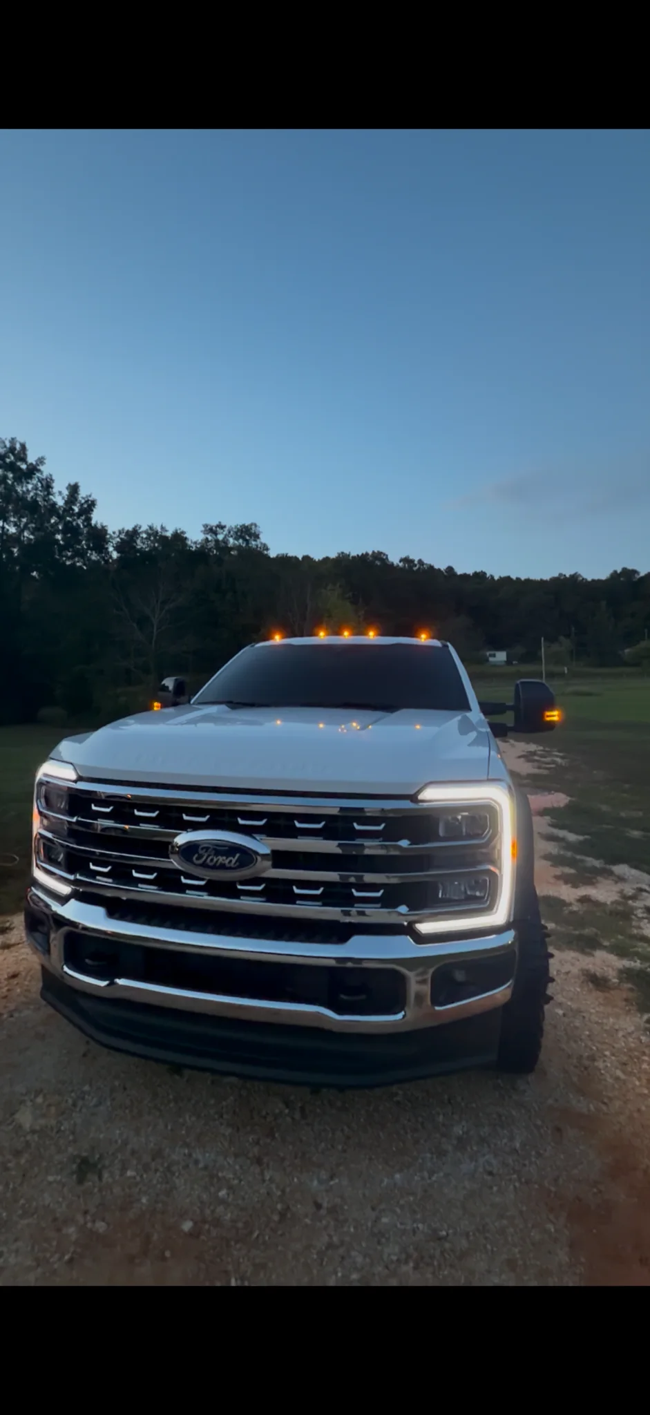 Freshly detailed white Ford Super Duty at dusk